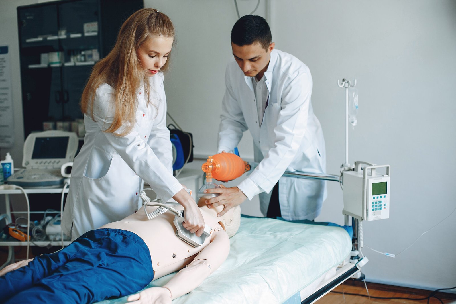 man and woman are learning to provide first aid.