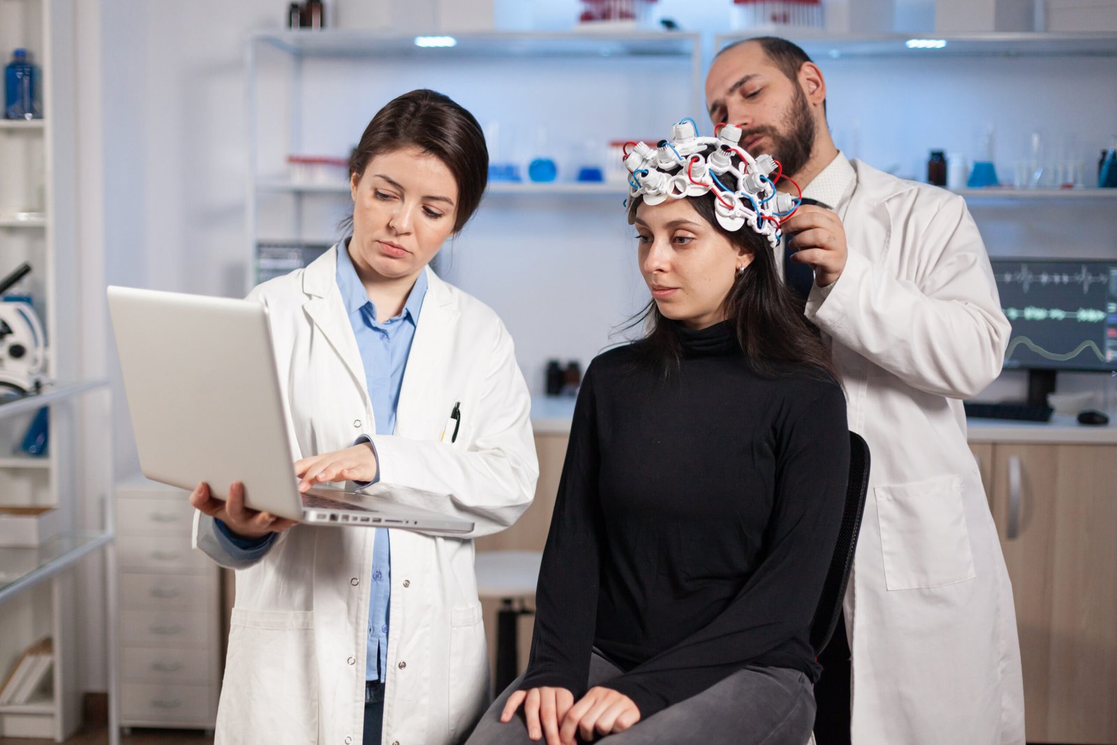 specialist neurologist doctor taking notes on laptop asking patient's symptoms